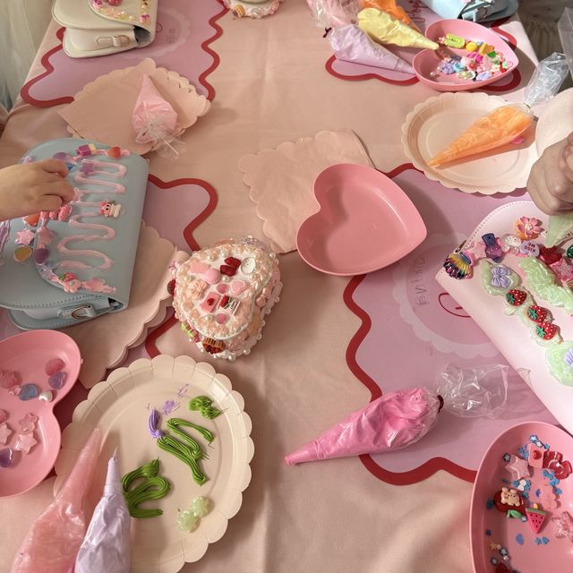 Guests piping cream onto handbags and a heart jewellery box at a Popi party table