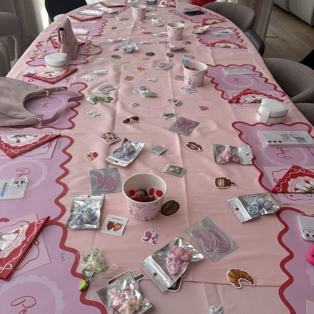 A Popi party table set before guests arrive, with named places and charm packs at every seat